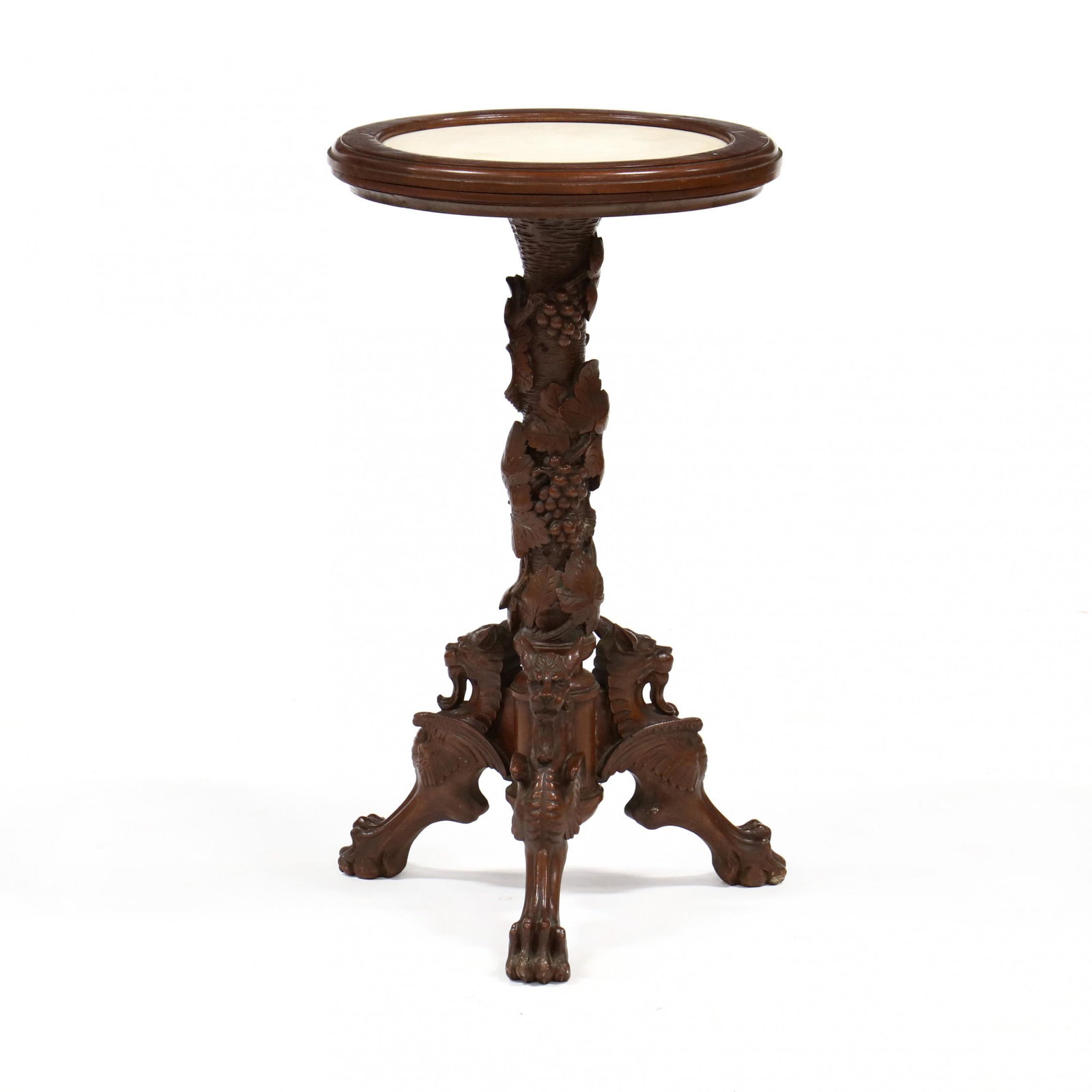 American Renaissance Revival Carved Walnut and Marble: American Renaissance Revival Carved Walnut and Marble Top Stand late 19th century, inset circular white marble top, well developed and carved pedestal with grapevines and winged griffins. 30 x 17 in. 