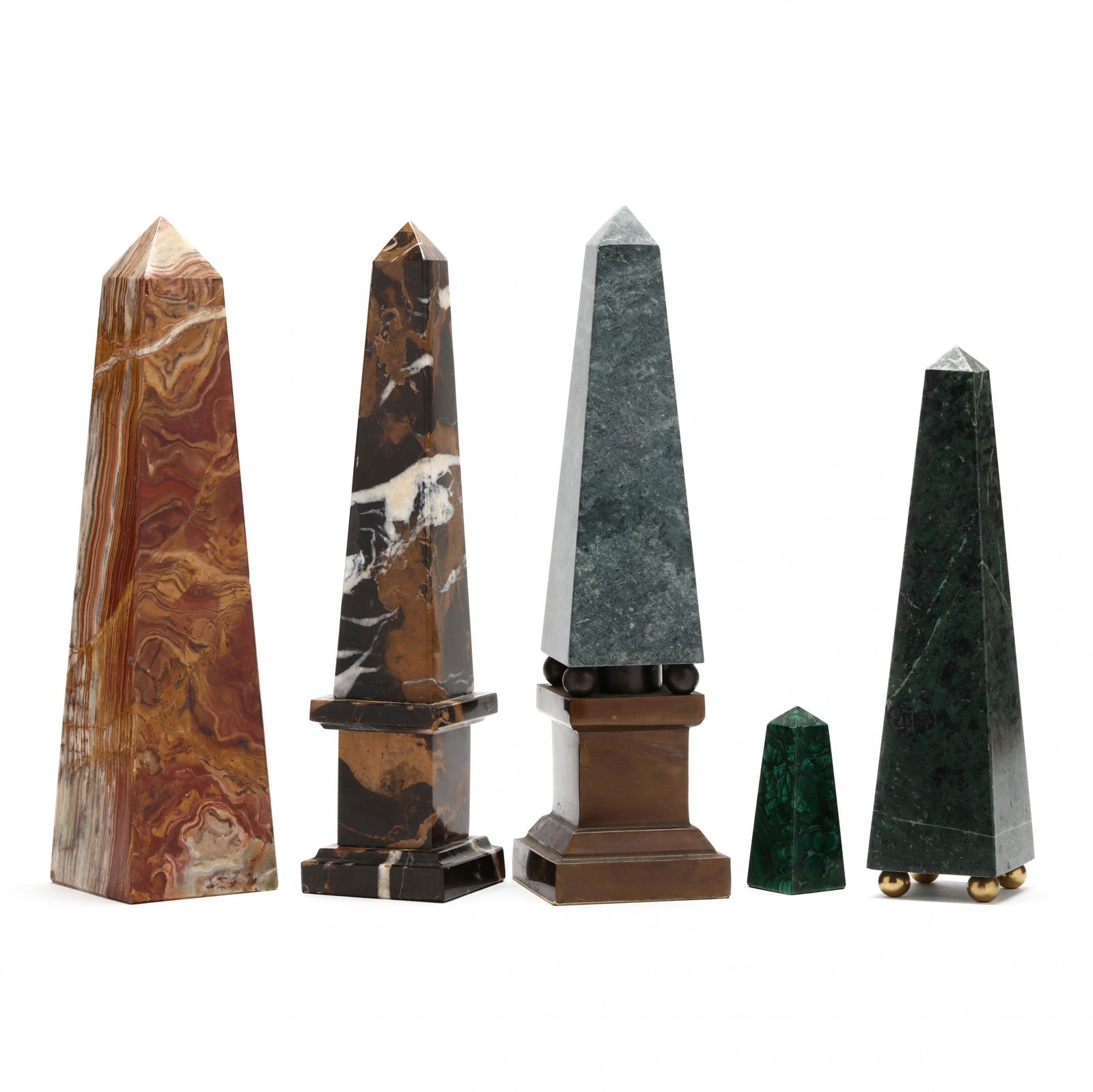 Five Stone Obelisks: Five Stone Obelisks20th century, in varying heights, each unmarked, the first in black white and sienna toned marble, mounted atop a plinth (11 3/4 in.); the second in warm beige and sienna toned jasp
