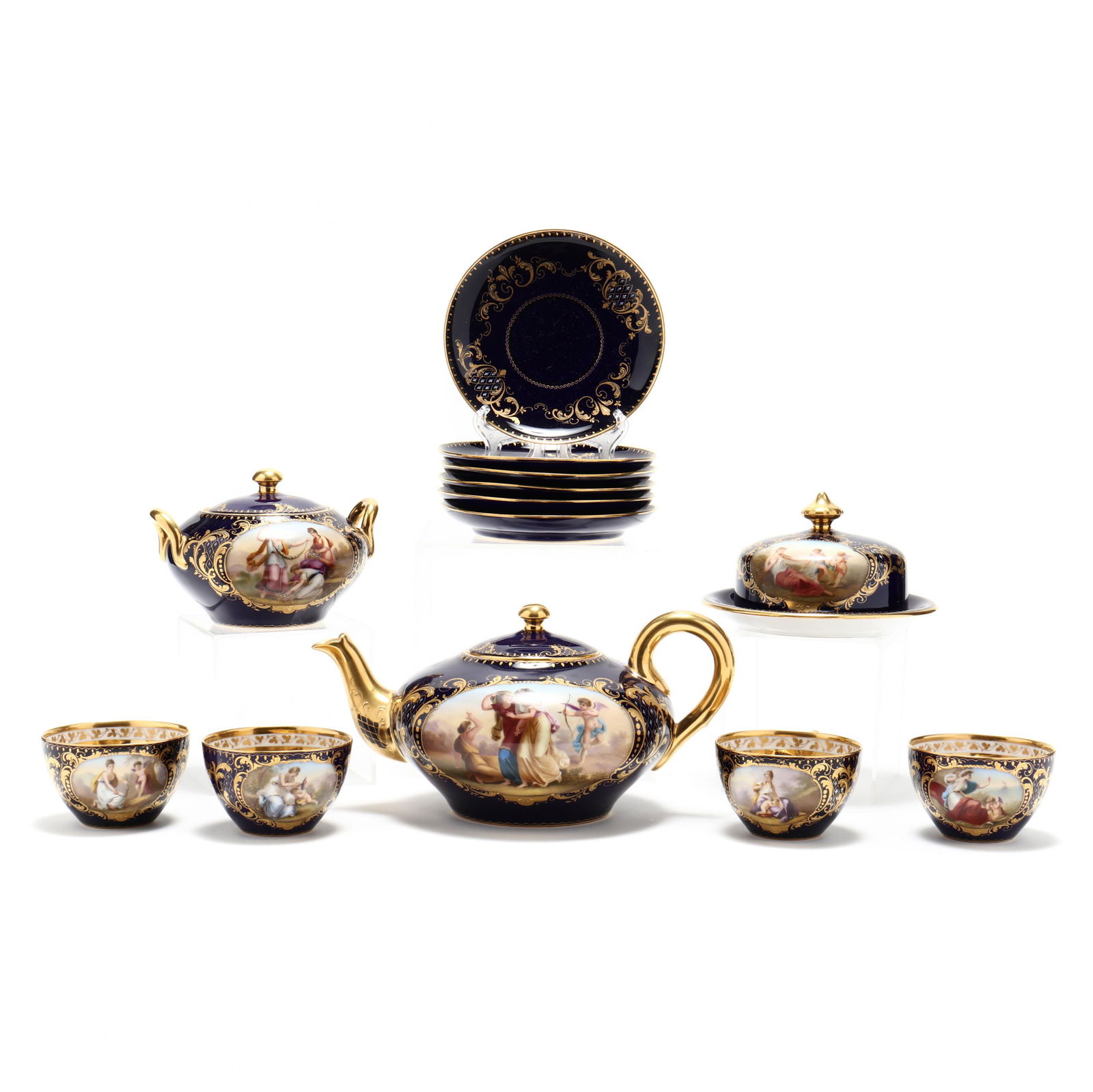 Royal Vienna Style Tea Service for Six: Royal Vienna Style Tea Service for SixLate 19th century, hand-painted with gilt arabesques and classical vignettes upon a cobalt field, the set, comprising four cups and six saucers, with covered teap