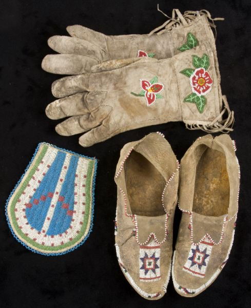 (3) Pieces of Native American Beadwork,: the first a pair of hide moccasins, 10" long, with collector's label claiming them to be Crow, late 19th c.; the second a pair of hide gauntlets, 11" long, with floral beadwork, quite stiff with age;