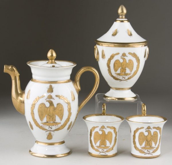 Sevres Porcelain Tea Set With Napoleonic Theme,: 19th c., consisting of tea pot, 7"; lidded sugar, 6.5"; (2) tea cups, 3", each piece with heavily gilt designs anchored by a Napoleonic eagle in wreath, house flies are whimsically scattered throughou