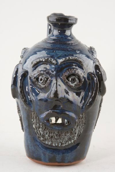 GA Folk Pottery, Bobby Ferguson Triple Face Jug,: deep blue glaze, each face having inscribed beard and eyebrows, china plate teeth, the jug with a single scrolled handle, the bottom inscribed "Bobby Ferguson Gillsville GA". 9.5"