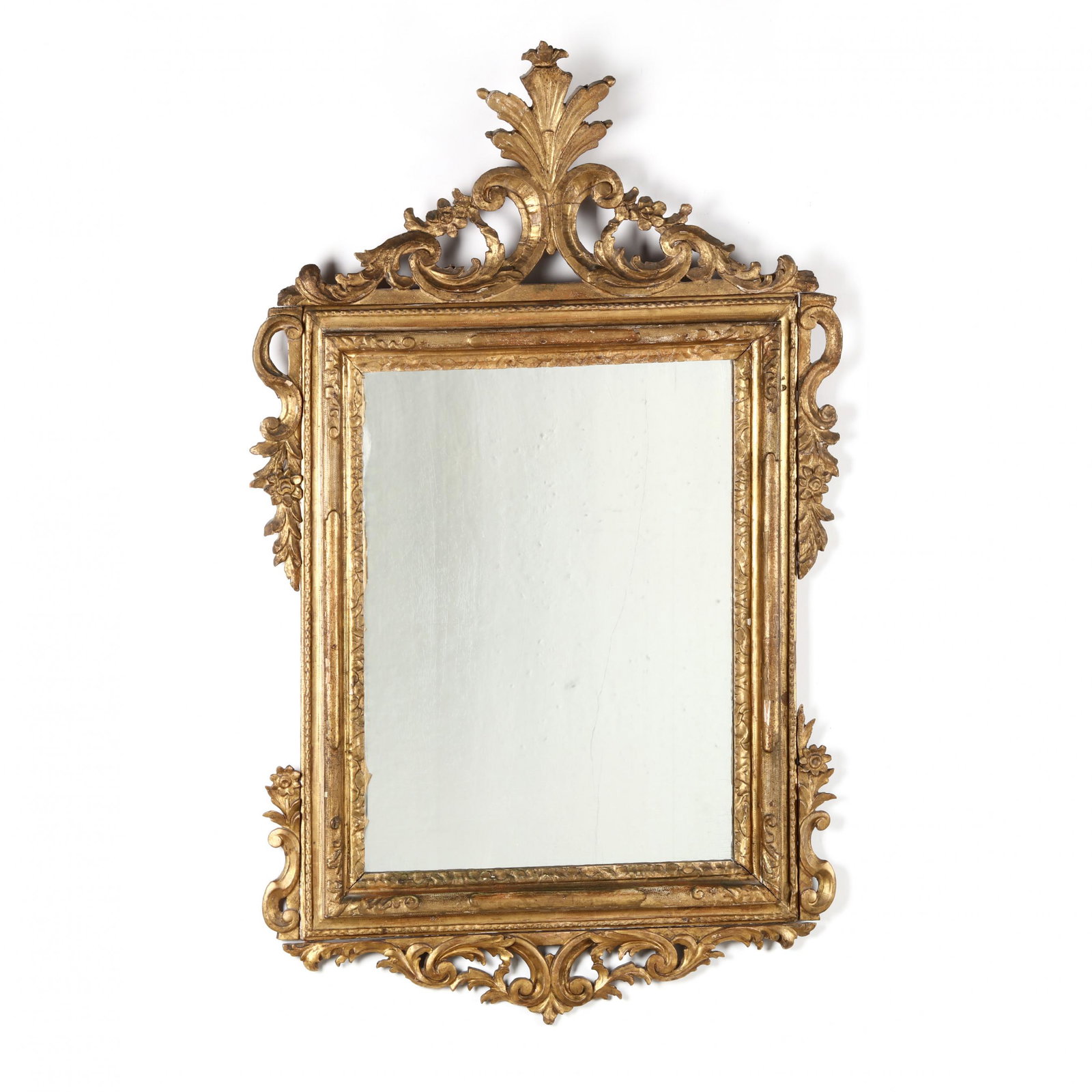 Antique Italian Carved and Gilt Mirror: Antique Italian Carved and Gilt Mirror 19th century, wood and gesso frame, rectangular mirror with cove molded frame featuring pierced scrolled and foliate carvings, unmarked. 56 x 34 in. From the Col