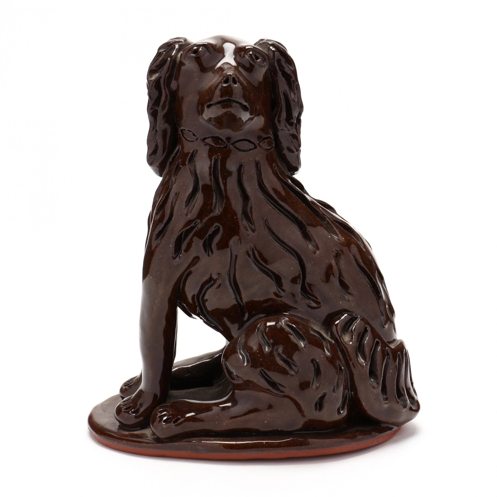 NC Folk Pottery, Billy Ray Hussey, Seated Spaniel: NC Folk Pottery, Billy Ray Hussey, Seated Spaniel glossy brown glazed earthenware, realistic features, carved fur and chain collar, raised on a small platform, incised on the underside, "Owens BH". 7.