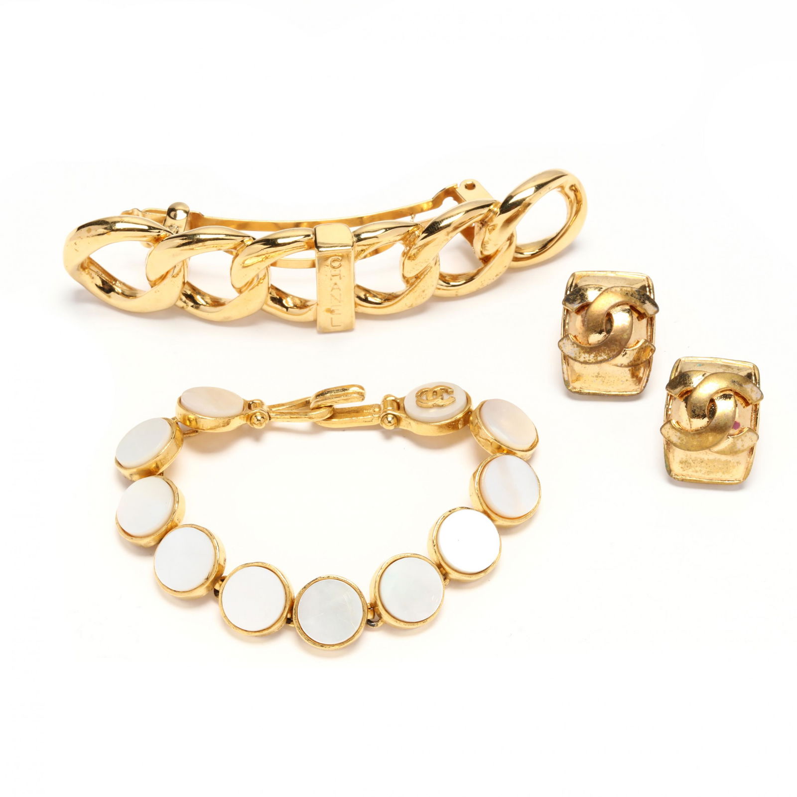 Three Pieces of Chanel Fashion Jewelry: Three Pieces of Chanel Fashion Jewelryto include: a hair clip, gold tone (4 in.) (appears unused); a link bracelet, each circular link set with abalone dated 1995 (LOA 7 1/2 in.) (good condition); a p