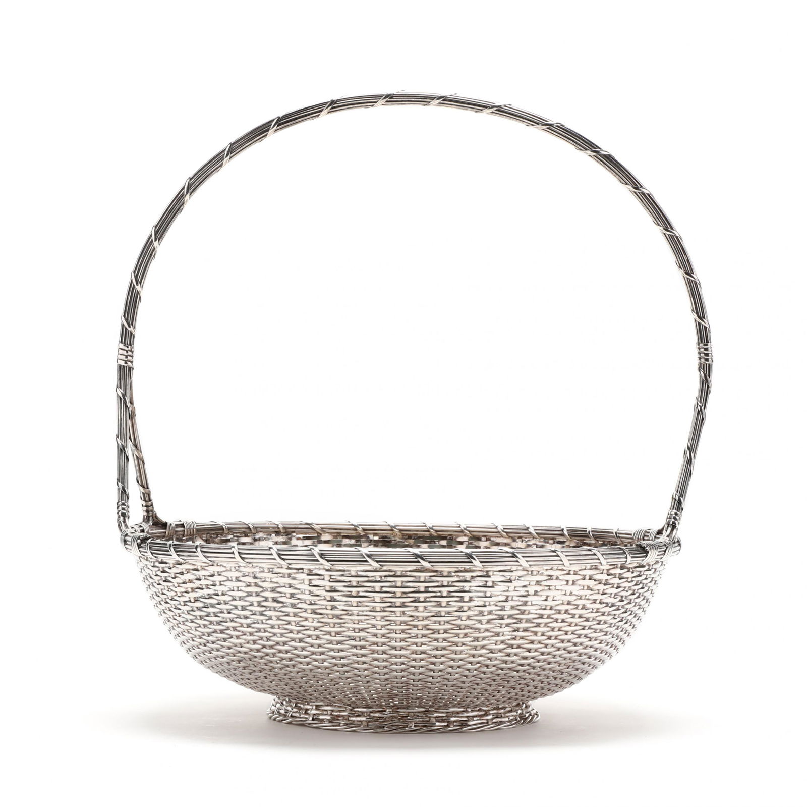 A Large Christofle Silverplate Basket: A Large Christofle Silverplate Basketmid-20th century, marked "Christofle Paris" to base and with two hallmarks, marked to base, with fixed handle, intricate woven silverplate basket, no monograms or