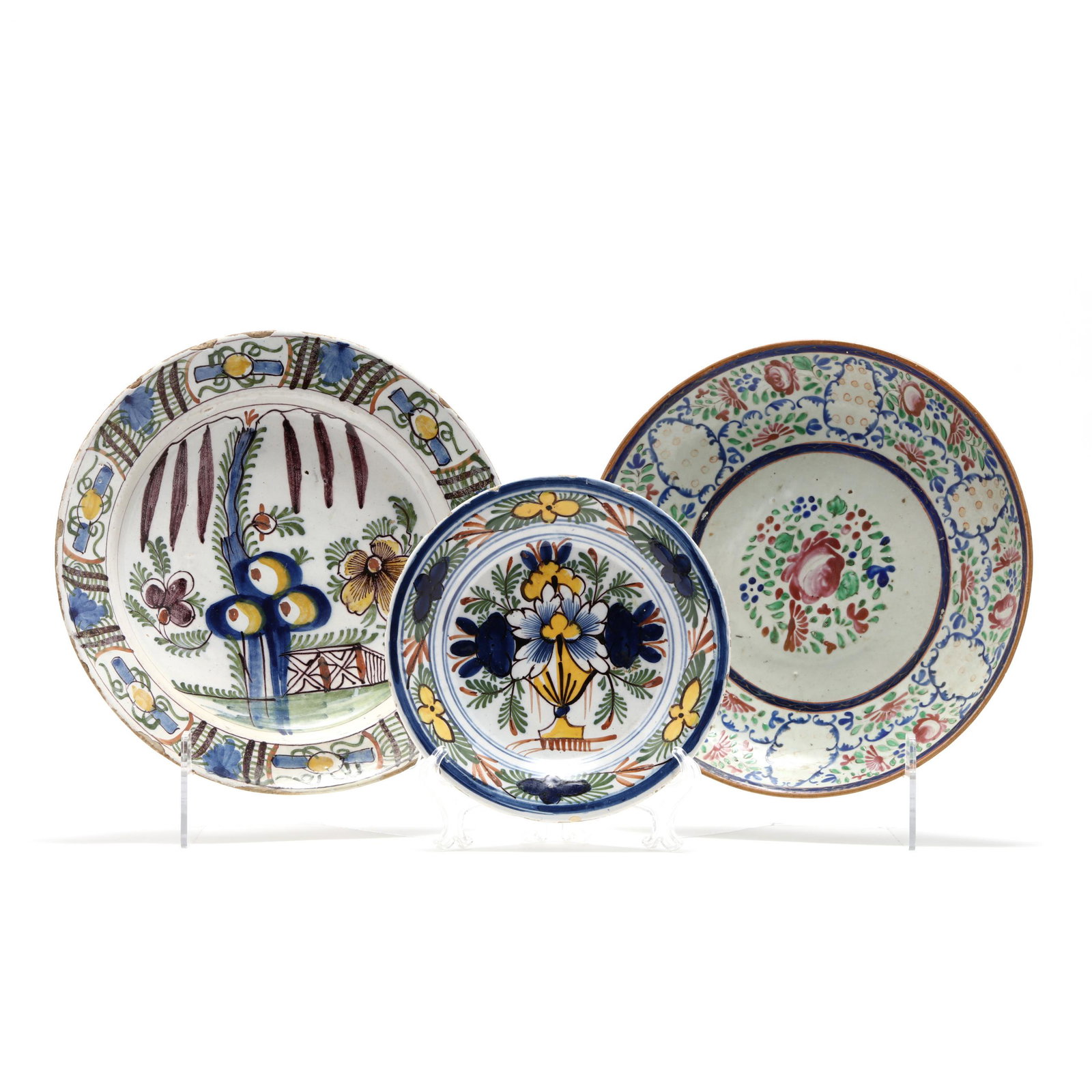 Three Deft Plates: Three Deft Plates the first is an early 18th century charger, five color polychrome of a garden (2 x 12 3/4 in.) (approx. 6 in. rim/border restoration; other chips); the second is late 18th-early 19th