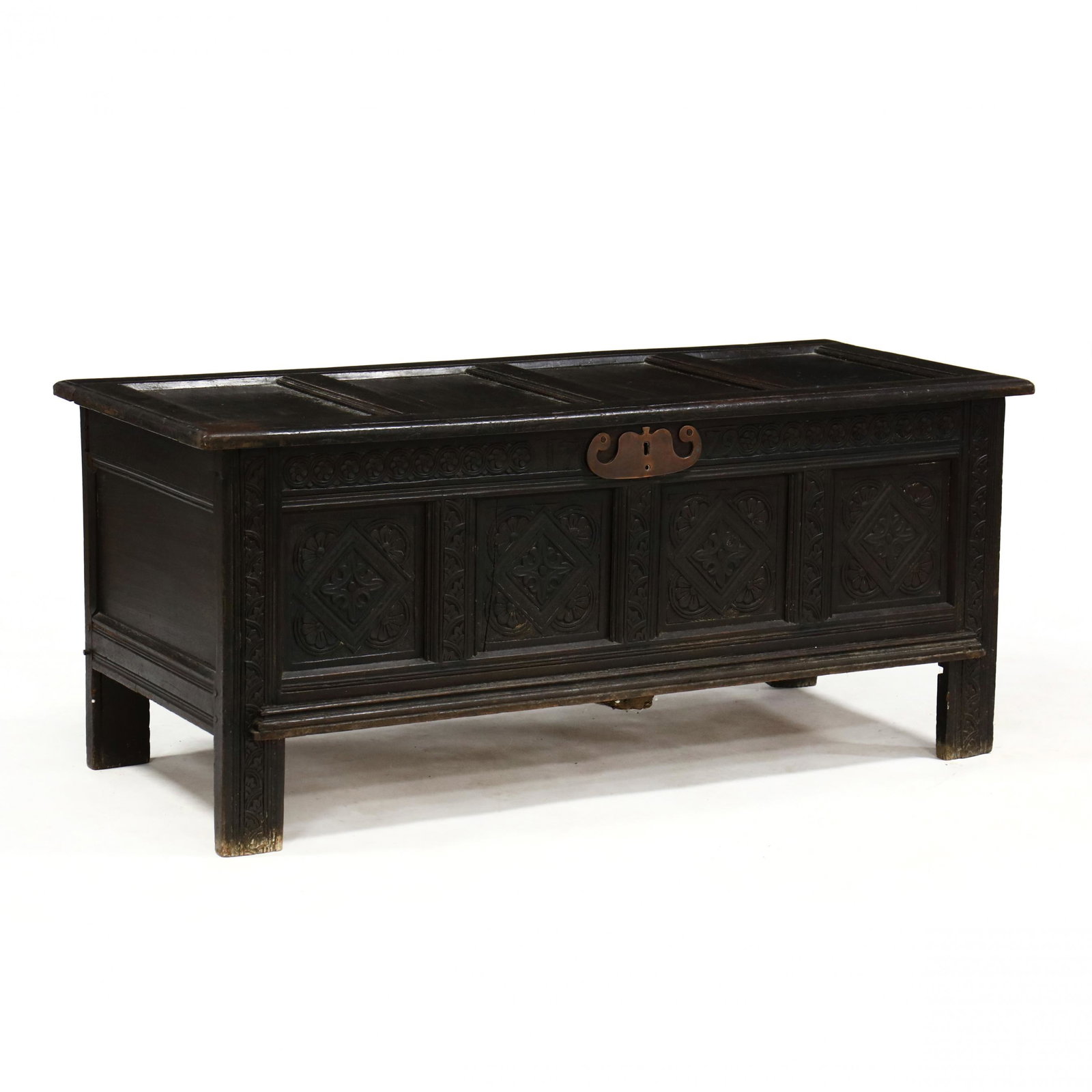 An English William and Mary Carved Oak Blanket Chest: An English William and Mary Carved Oak Blanket Chest late 17th century, quadruple paneled top with molded edge, open interior, the front panels with relief floral and geometric carving, paneled sides,