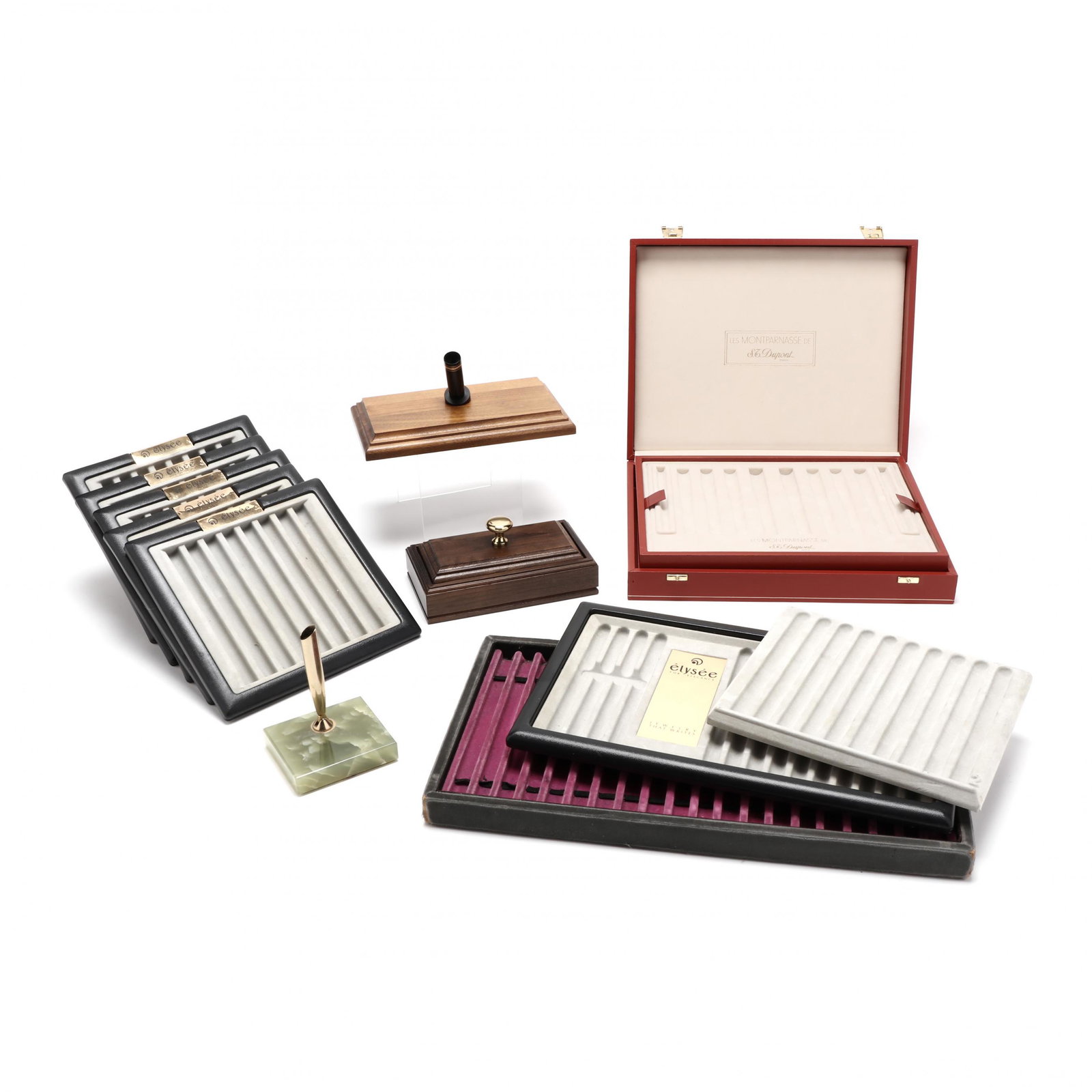Grouping of Pen Trays and Accessories: Grouping of Pen Trays and Accessories including a Montblanc walnut stand, a green onyx and gold tone pen stand, a walnut and brass blotter, and nine trays and cases. Largest tray 8 1/4 x 14 3/4 in. Ad