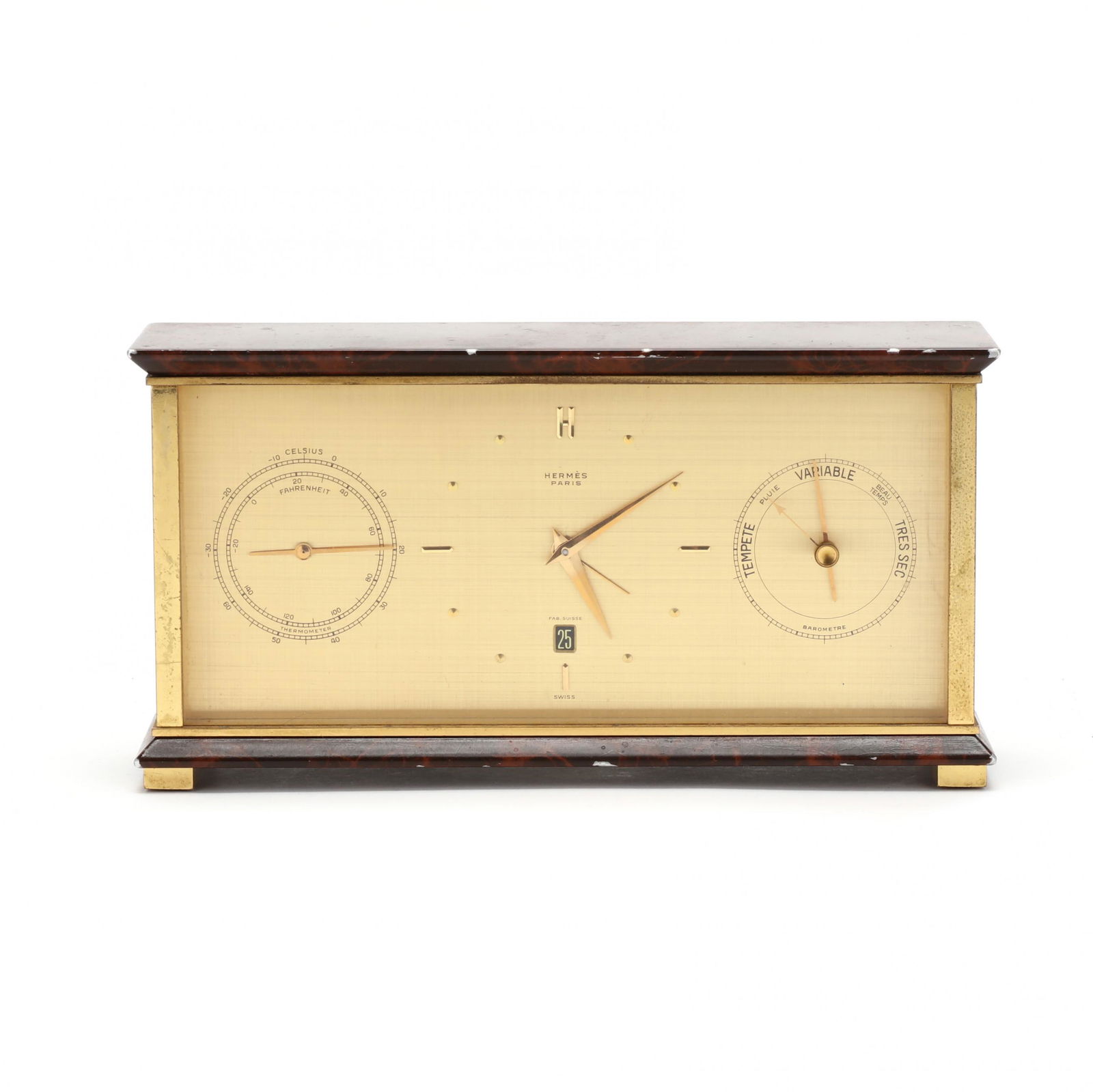 HermÃ¨s Weather Station Desk Clock: HermÃ¨s Weather Station Desk Clockcirca 1970s, with center clock dial above a date aperture, flanked with a barometer and a thermometer, signed and with Swiss works, brass case with faux shell ename