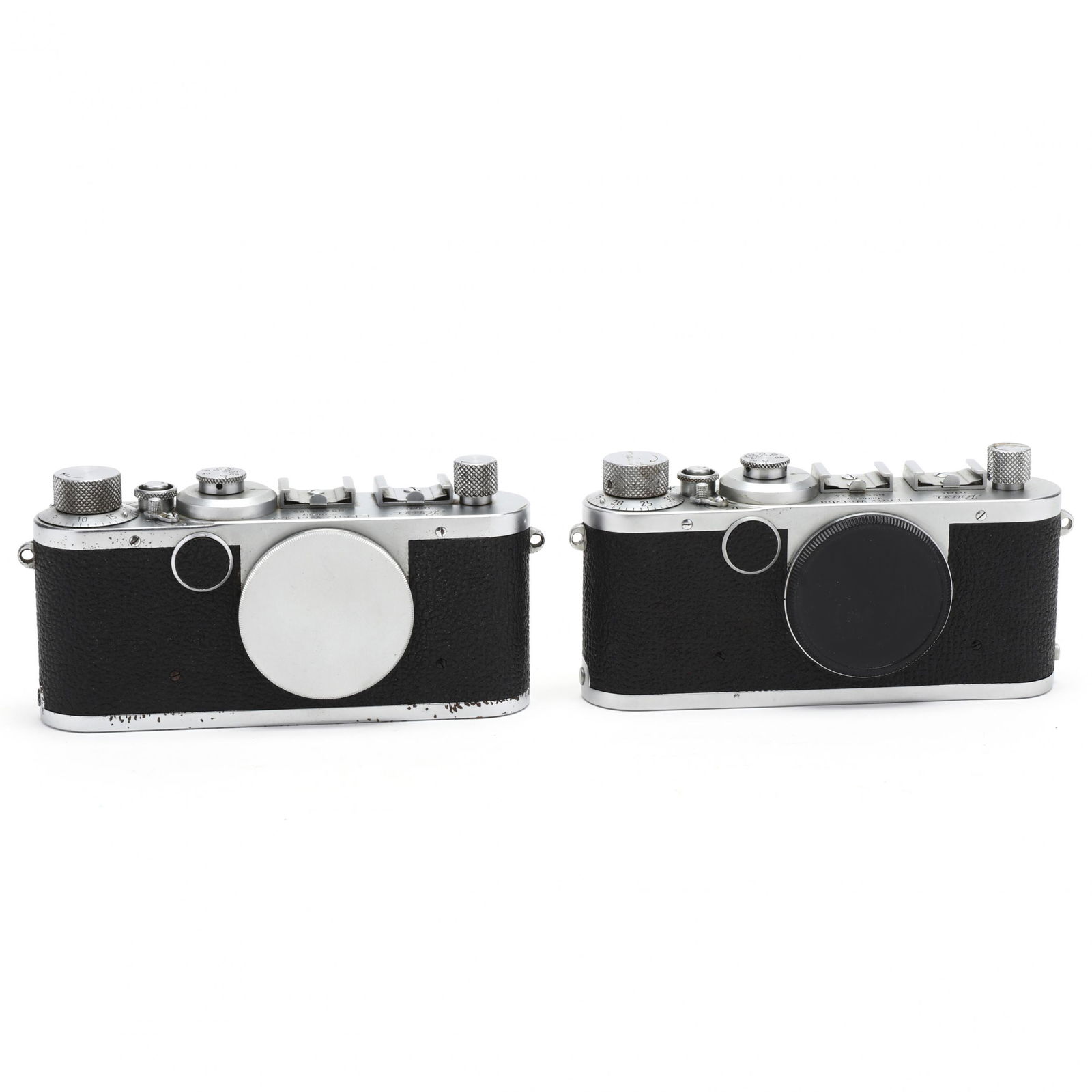 Pair of Vintage Leica D.R.P. Leitz Wetzlar Rangefinder: Pair of Vintage Leica D.R.P. Leitz Wetzlar Rangefinder Cameras, Each Without LensGermany, No.'s 458185 (1950) and 521234 (1950) both without lenses. 2 3/8 x 5 3/4 x 1 1/4 in. Private Collection of a G
