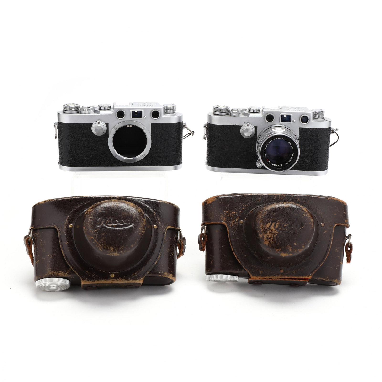 Pair of Nicca Camera Co. 3-F Vintage Cameras, One with: Pair of Nicca Camera Co. 3-F Vintage Cameras, One with Nikkor Lens 1957, Leica copy, rangefinder camera, No.'s 153287 and 155428, both lever wind versions, 153287 is fitted with Nikkor - H.C 1:2 f=5cm