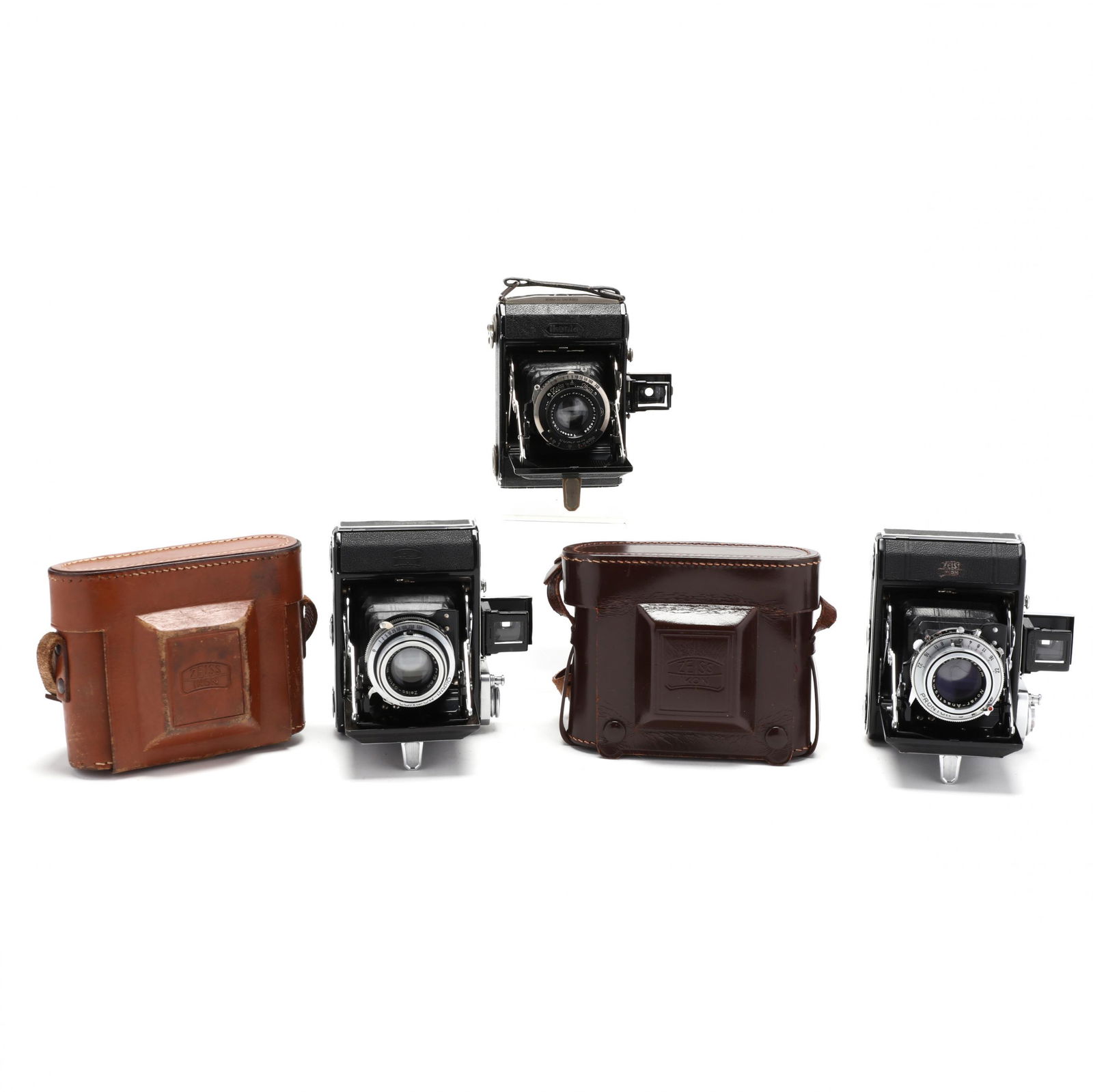 Three Vintage Zeiss Ikon Ikonta 521 Folding Cameras,: Three Vintage Zeiss Ikon Ikonta 521 Folding Cameras, Two PrewarGermany, circa 1935-1954, the first with Carl Zeiss Jena Nr. 1414924 Tessar 1:3,5 f=7cm lens, Compur shutter (prewar); the second with Ze
