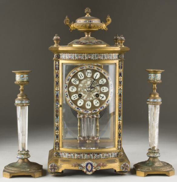 French Cloisonne Mantel Clock Garniture Set: French Cloisonne Mantel Clock Garniture Set unsigned gilt brass and Cloisonne mercury pendulum clock having beveled glass sides, the whole topped with decorative two-handled urn and four finials. The