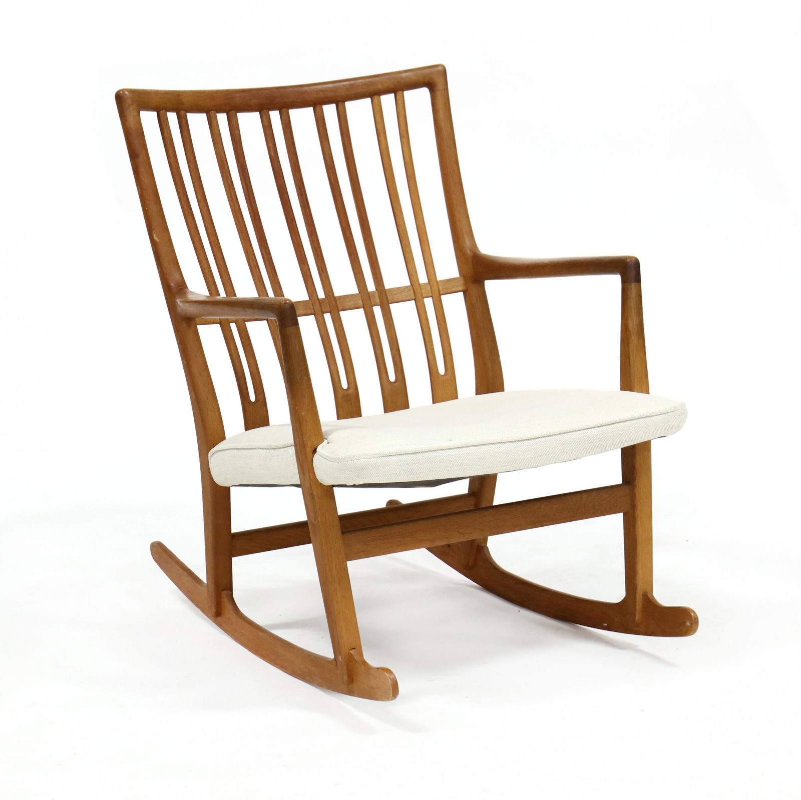 Hans Wegner (Denmark, 1914-2007), ML-33 Teak Rocking: Hans Wegner (Denmark, 1914-2007), ML-33 Teak Rocking Chair1940s, for Mikael Laursen, straight crest rail with pierced Y shaped back splats, white upholstered seat, shaped arms, unmarked. 31.5 x 24.5 x