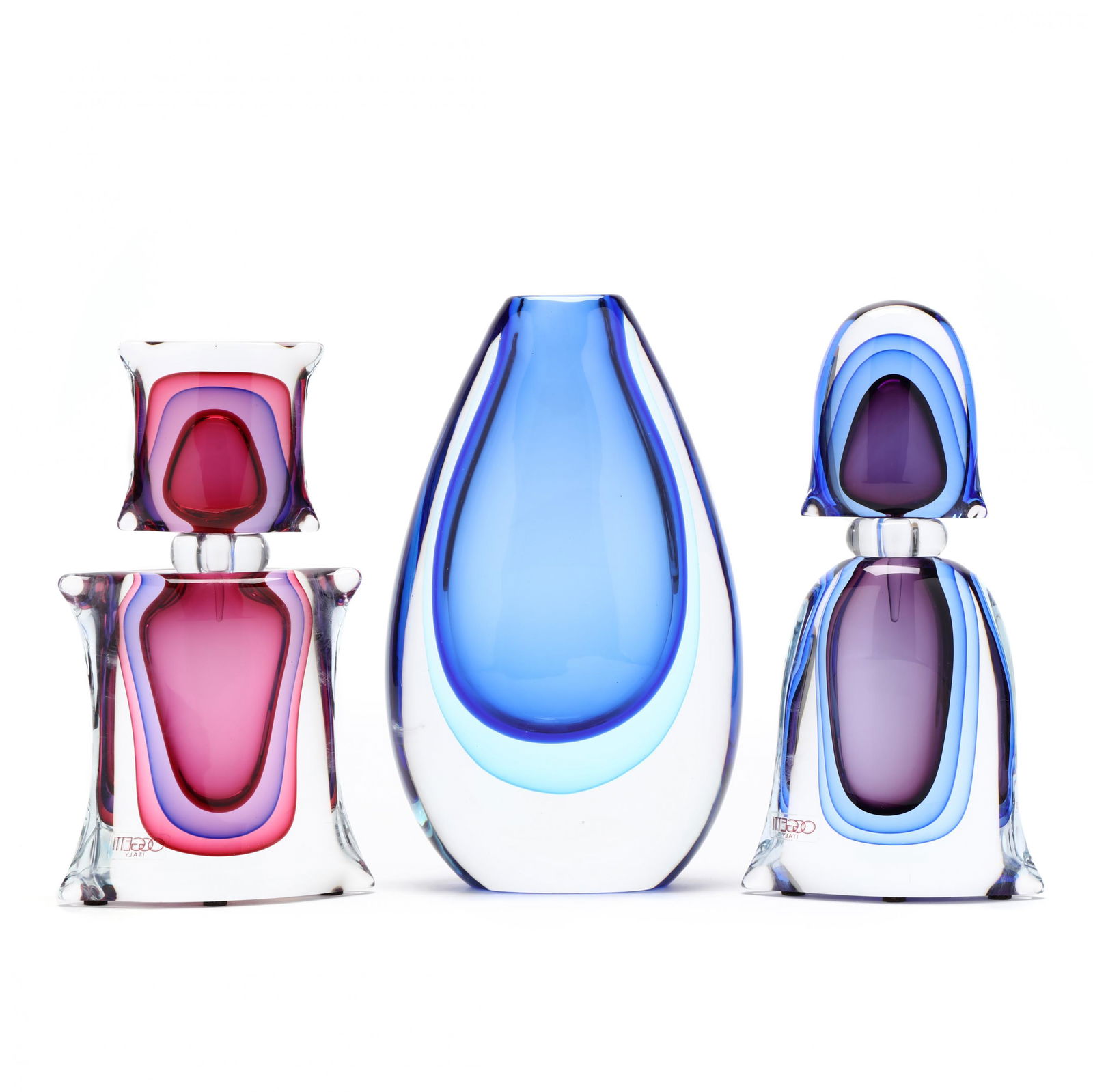 Luigi Onesto (Italy, born 1935), Sommerso Art Glass: Luigi Onesto (Italy, born 1935), Sommerso Art Glass Groupinglate 20th century, for Oggetti, including a vase in cased cobalt and turquoise layers, together with a pair of bottles in cased blue and pin