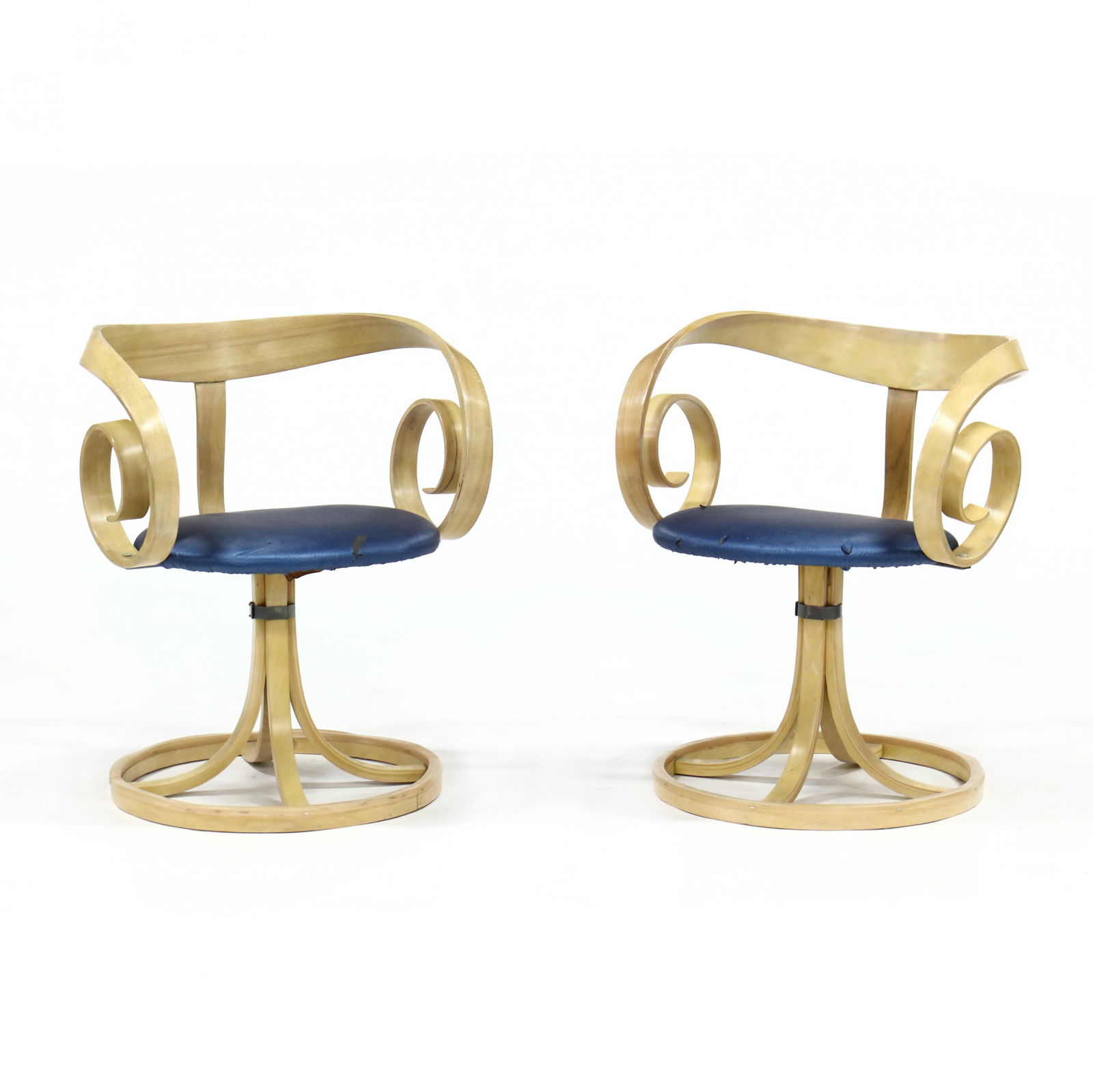 George Mulhauser (Am., 1922-2002), Pair of Sultana: George Mulhauser (Am., 1922-2002), Pair of Sultana ChairsPlycraft, 1960s, laminated maple, each swivel chairs with later blue vinyl upholstery on laminated scrolled maple base, labeled. 26.25 x 24 x 2