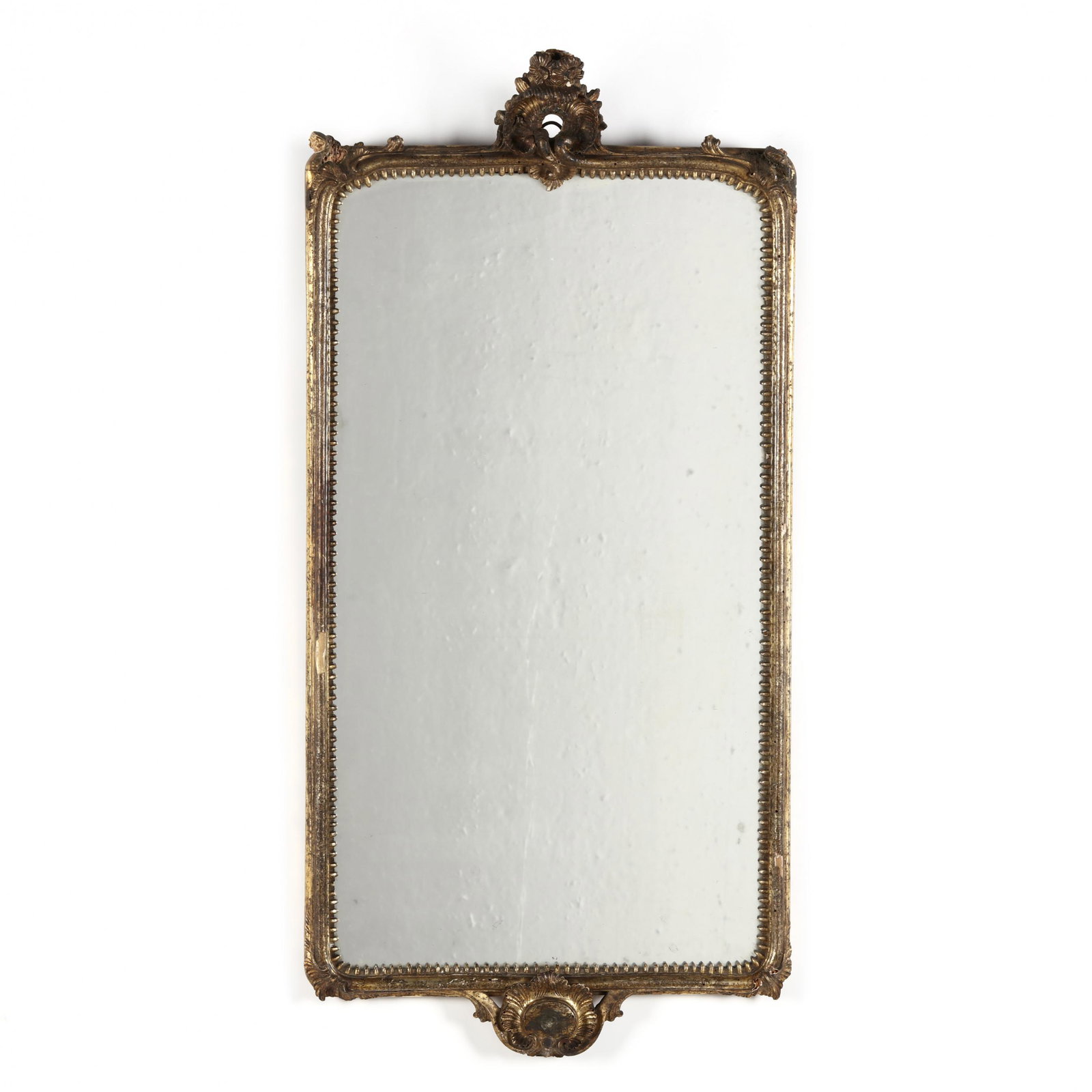 Antique French Rococo Style Giltwood Mirror: Antique French Rococo Style Giltwood Mirror 19th century, carved wood, gesso and gilt, ornate carved shell and floral pediment and corners details on a molded frame with curved corners, a gadrooned to