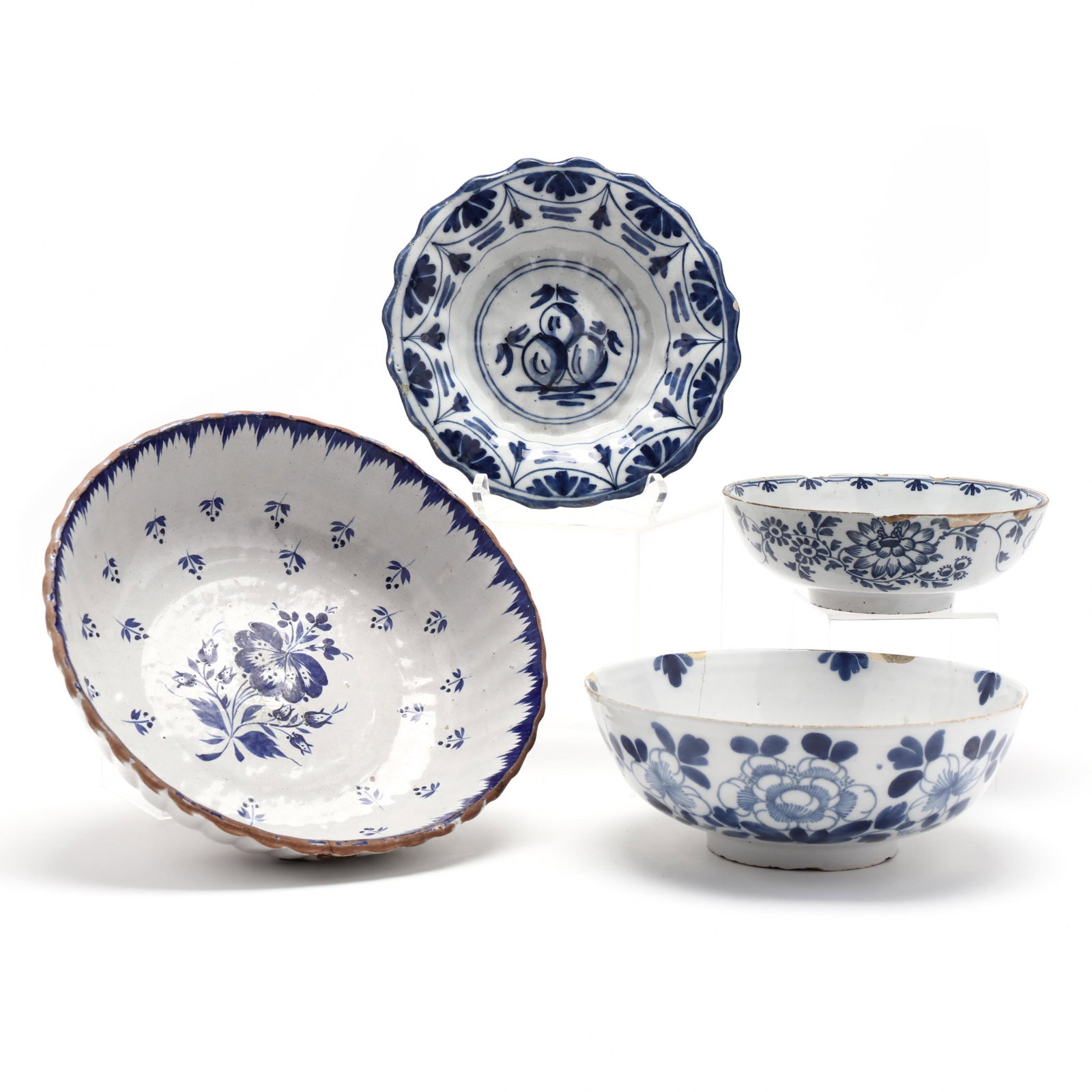 A Group of Four Blue and White Painted Delft Bowls: A Group of Four Blue and White Painted Delft Bowls 18th-19th century, the first has a red-brown painted rim, molded body (3 1/4 x 1 in.) (break and hairline with staple repair); a simply decorated foo