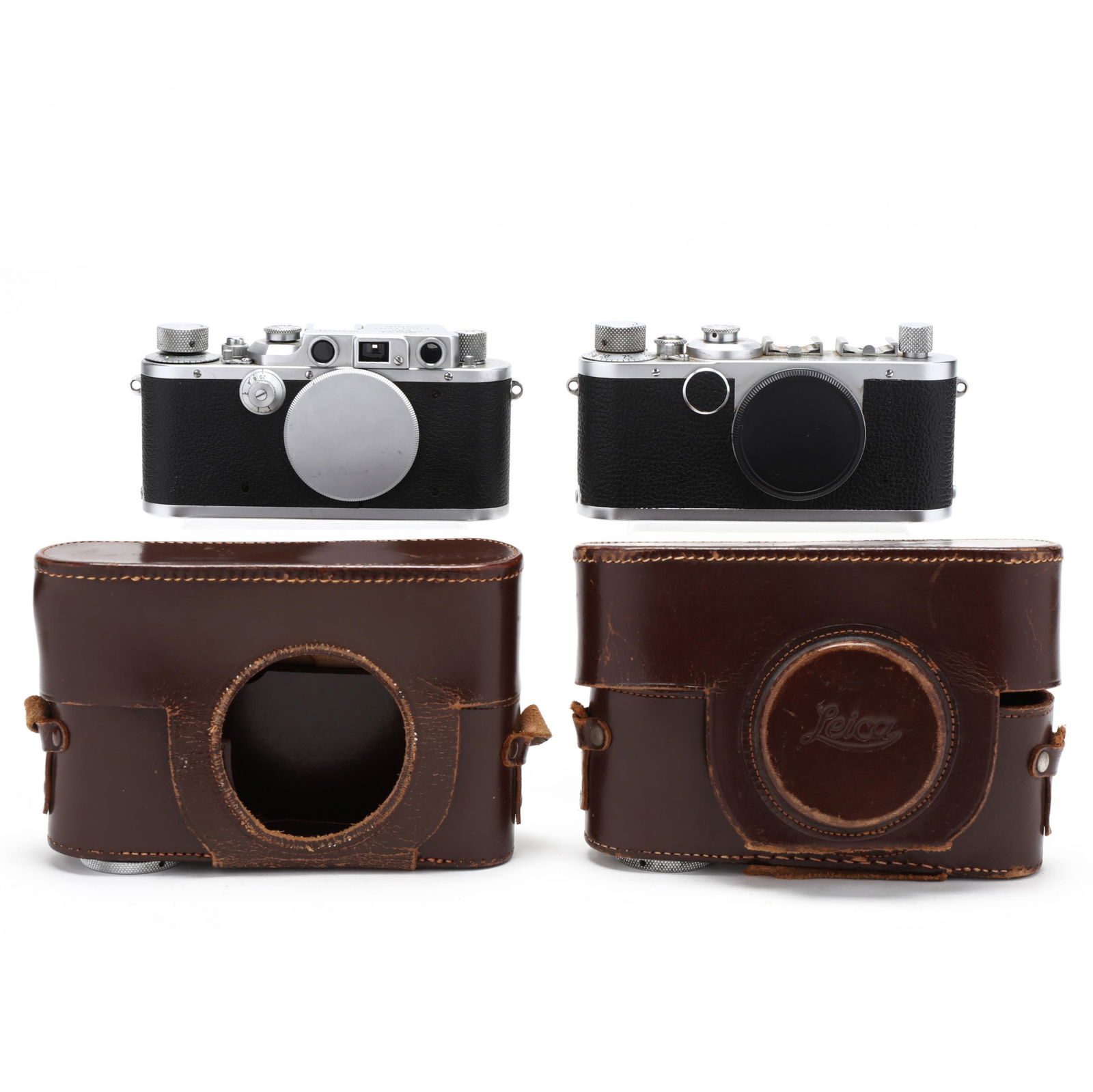 Pair of Vintage Leica D.R.P. Leitz Wetzlar Rangefinder: Pair of Vintage Leica D.R.P. Leitz Wetzlar Rangefinder Cameras, each without LensGermany, No.'s 328364 (1939) and 522062 (1950), each without lenses but includes Leica leather case. 2 3/8 x 5 3/4 x 1