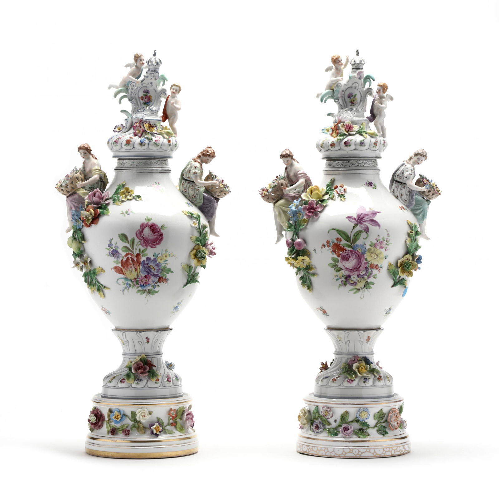 A Pair of Carl Thieme Potschappel Dresden Urns: A Pair of Carl Thieme Potschappel Dresden Urns19th century, with cover and stand, the urn is lavishly decorated with flowers, both painted and applied, a draped maiden perched at each shoulder, the co