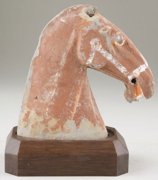 Chinese Han Dynasty Ceramic Horse's Head: Chinese Han Dynasty Ceramic Horse's Head 207 B.C. - 220 A.D., gray earthenware with red slip, painted bridle, eyes and mouth. Rests on a custom wooden base. 6.5 in. Ex. William Chak Collection.