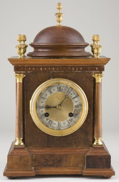 German Presentation Mantel Clock: German Presentation Mantel Clock time and strike; brass movement marked "Deutches Reichpatent 61,225" and numbered 9287; engraved steel dial in brass frame; domed mahogany and burled wood case pierced