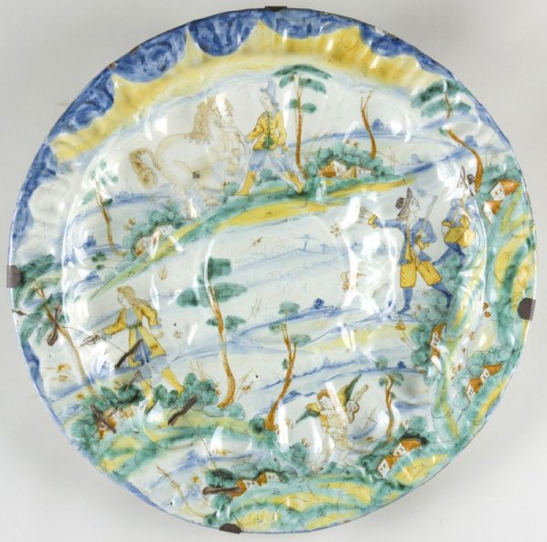 17th Century Italian Maiolica Dish, att. Deruta: 17th Century Italian Maiolica Dish, att. Deruta round dish with large raised central well, molded form, the whole with hand-painted landscape with figures, horse, and cupid playing the violin, with an