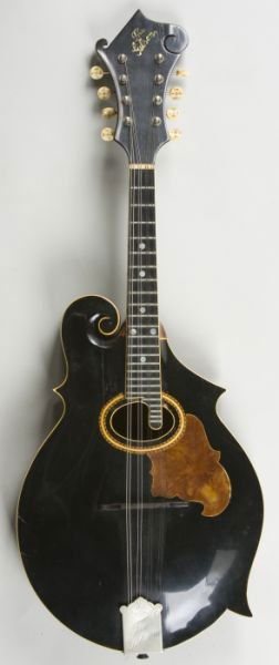1907 Gibson F-2 Mandolin: 1907 Gibson F-2 Mandolin serial #7136 penciled on Orville Gibson inner label; early three point body, bound blackface top with oval soundhole, inlaid pickguard; inlaid logo on headstock; inlaid button