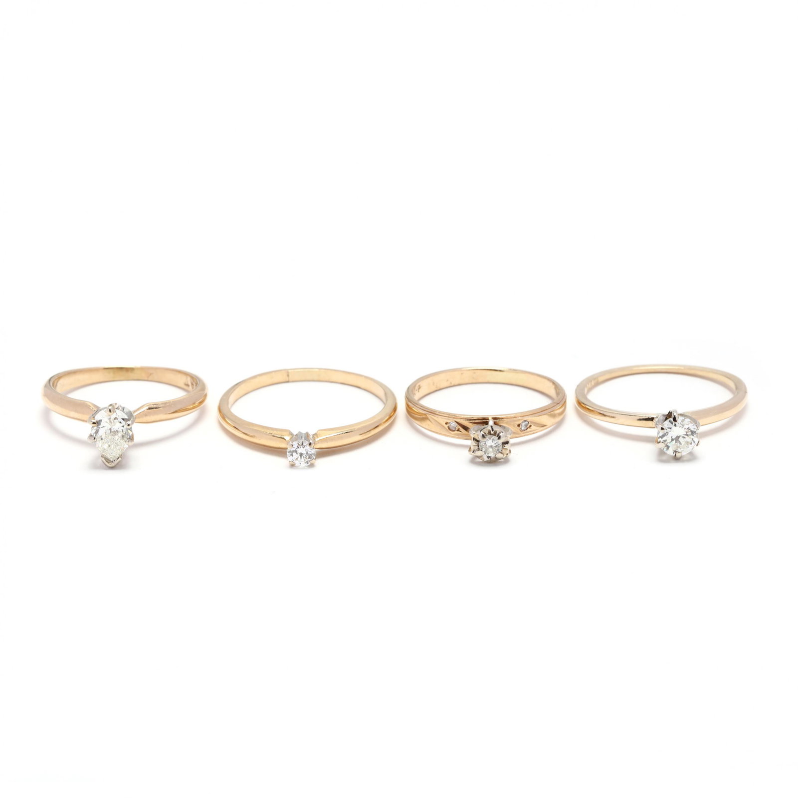 Four Gold and Diamond Solitaire Rings: Four Gold and Diamond Solitaire Rings one stamped 18K and in a four prong mount set with a round brilliant cut diamond weighing approximately .11 carat (I color, VS2 clarity); three rings stamped 14K 