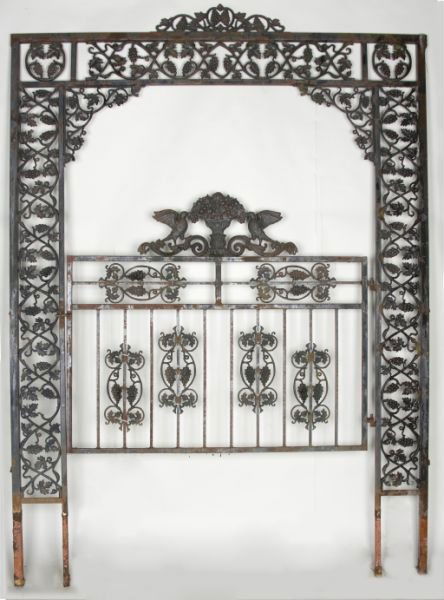 Cast Iron Garden Trellis with Gate: Cast Iron Garden Trellis with Gate early 20th century, uppermost crest with grape motif, the gate crest decorated with floral urn and birds. Gate 49 x 57 in. DOA 112 x 79 In. Some rust.