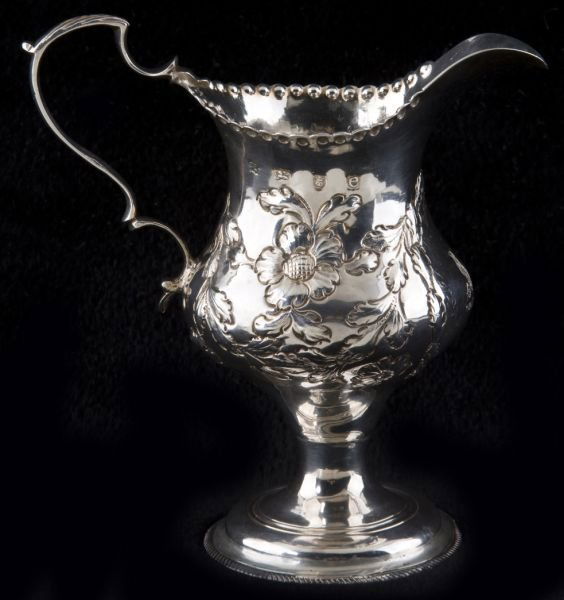 George III Sterling Cream Jug by Hester Bateman: George III Sterling Cream Jug by Hester Bateman London (1780) hallmarks, partially rubbed sponsor's mark for Hester Bateman, the pear form body with floral chased decoration to belly and punched decor