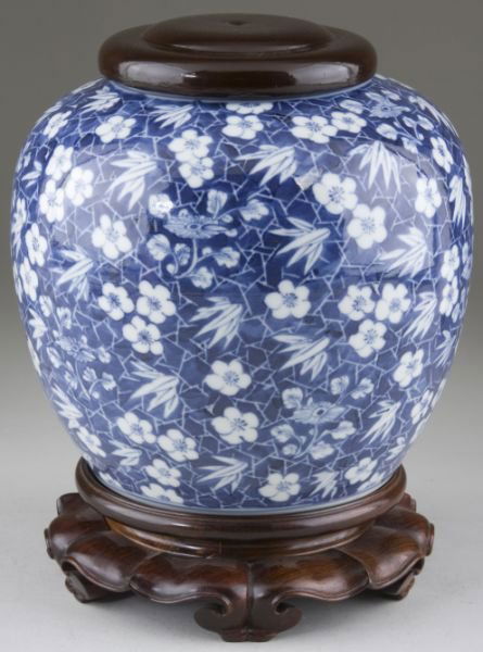 Chinese Hawthorne Jar: Chinese Hawthorne Jar likely 20th century, high shoulder with tapered body, allover blue and white blossom decoration, bottom with date marks that appear similar to the Ch'ien-lung Dynasty. Jar 8 in;