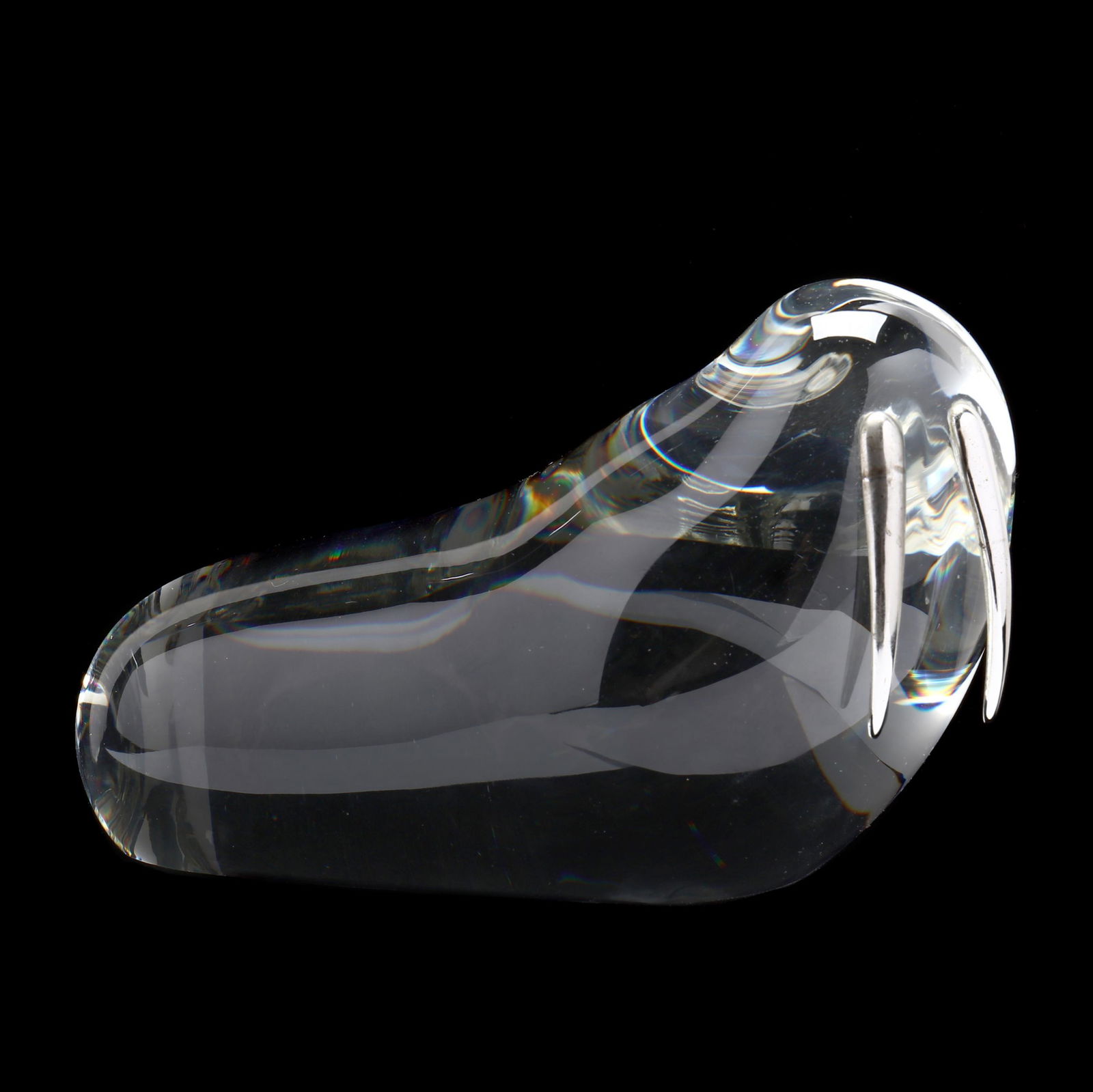 Paul Schulze (American, 1934-2010), Crystal Walrus for: Paul Schulze (American, 1934-2010), Crystal Walrus for Steuben1977, clear solid crystal with applied sterling silver tusks, signed Steuben to underside edge. 4.5 x 7.5 x 4 in. Paul Schulze is a gradua