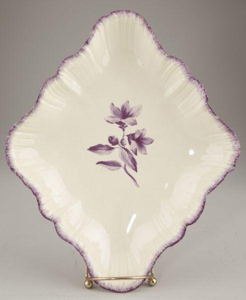 English 18th century Creamware Serving Plate: English 18th century Creamware Serving Plate diamond shaped with lilac feather edge and centered blossoming branch decoration. 1.5 x 11.75 x 9.75 in. Edge fritting. The Collection of Daisy Wade Bridge