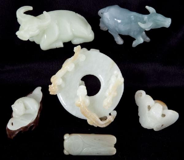 Seven Asian Jade Animal Figurines: Seven Asian Jade Animal Figurines included are (2) water buffalo, a ring with circling panthers, a cicada, a sleeping cat and a bat. 2.5 to 4 in. The Collection of Daisy Wade Bridges of Charlotte, NC