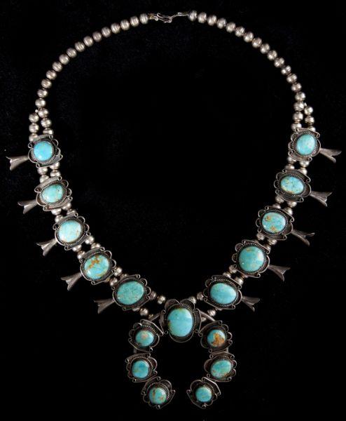 Native American Squash Blossom Necklace: Native American Squash Blossom Necklace single row of silver beads that joins a double row of silver beads strung with natural turquoise-inset beads tipped with large bugle shaped drops, central "blos
