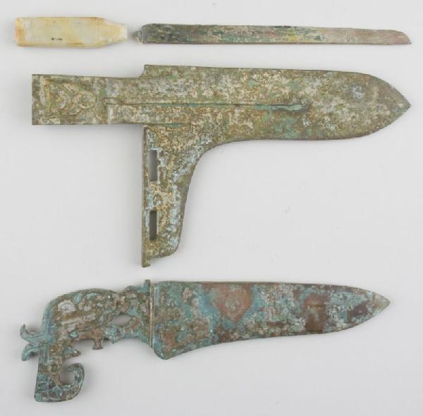 Three Ancient Chinese Bronze Weapons: Three Ancient Chinese Bronze Weapons the first a knife with jade handle attributed to the Eastern Zhou Dynasty, 1st millenium B.C. (6.75 in. blade; 9.5 in. DOA), corrosion and verdigris to detached bl
