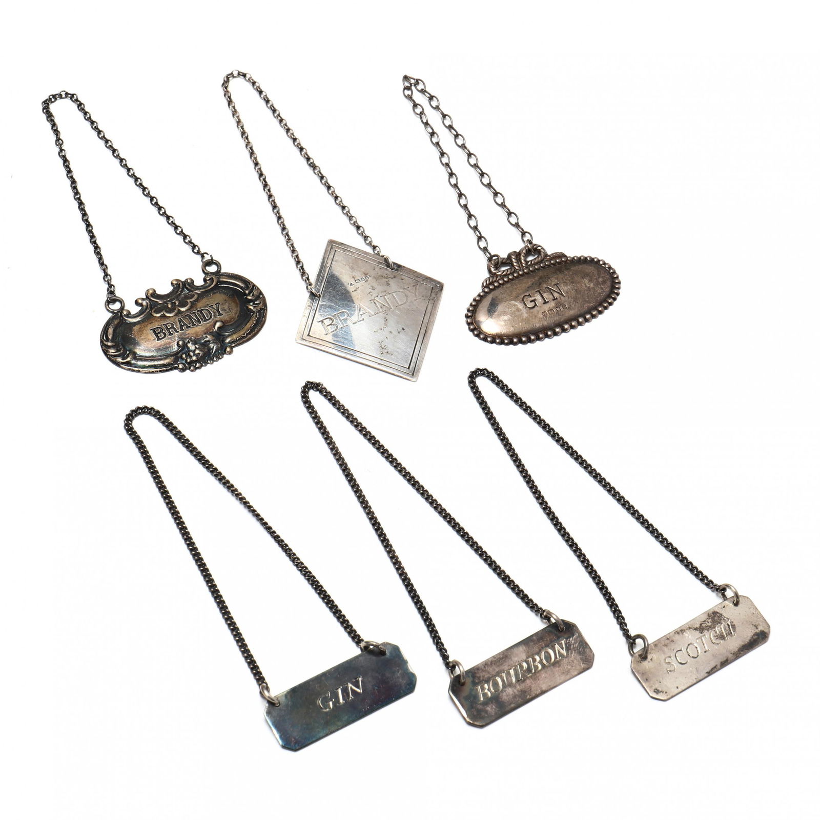 A Collection of Six Sterling Silver Decanter Tags (1 of 9)