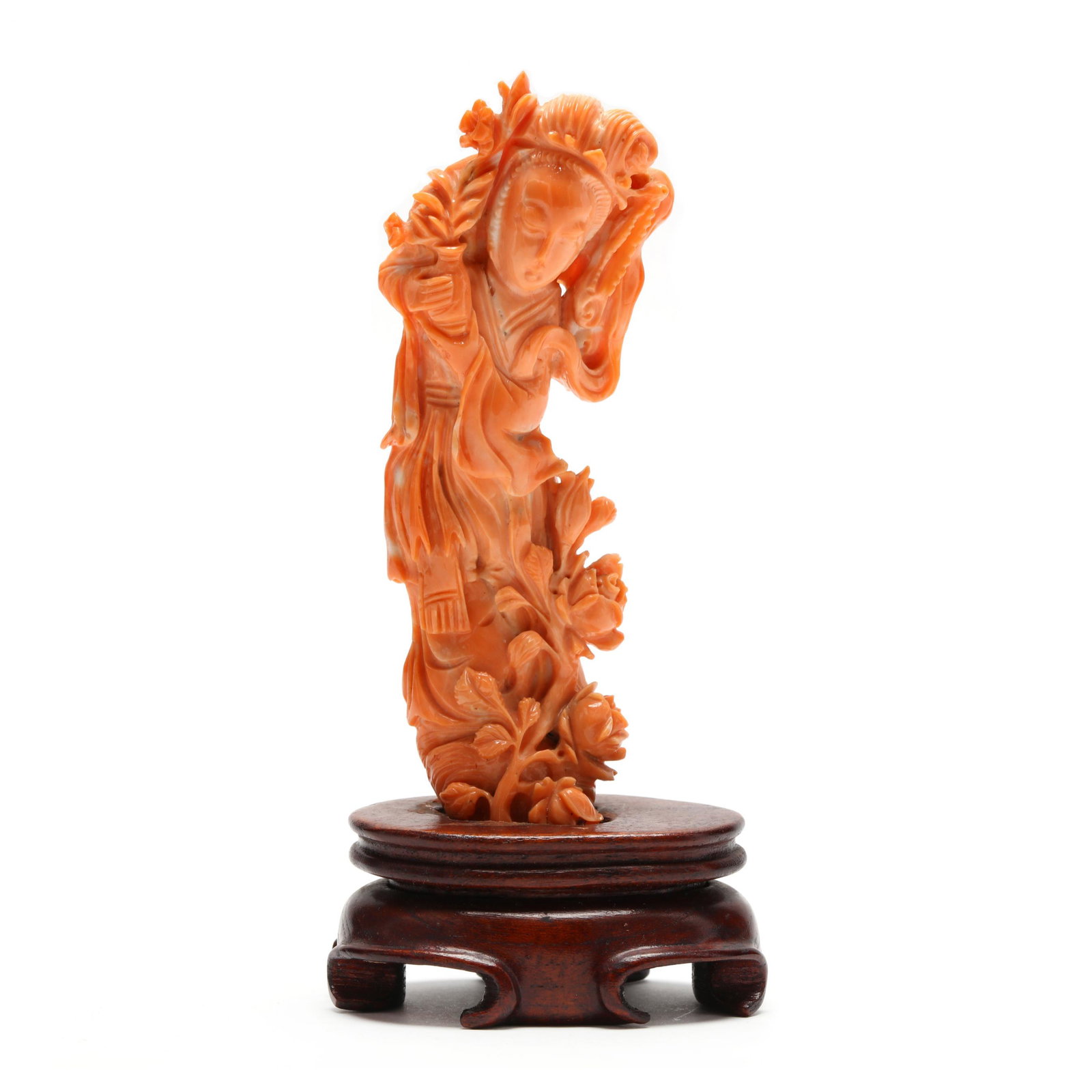 A Chinese Coral Carving of Guan Yin with Stand: A Chinese Coral Carving of Guan Yin with Stand finely carved coral in the image of the Bodhisattva of Compassion, Guan Yin, with flowing robes and holding a vase containing the nectar of life with bot