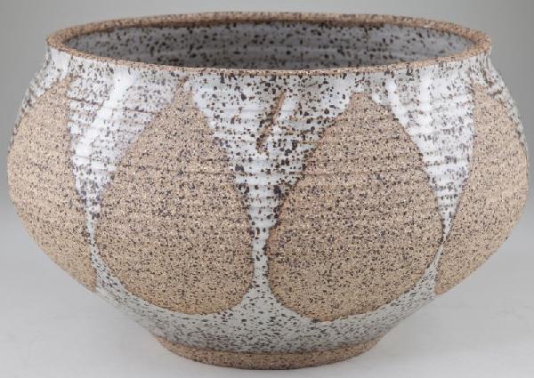 Karen Karnes Stoneware Centerbowl: Karen Karnes Stoneware Centerbowl wheel thrown bowl with raised rib design from the middle to the top of the bowl. A light blue and brown speckled glaze is applied to the bowl in a repeating leaf patt