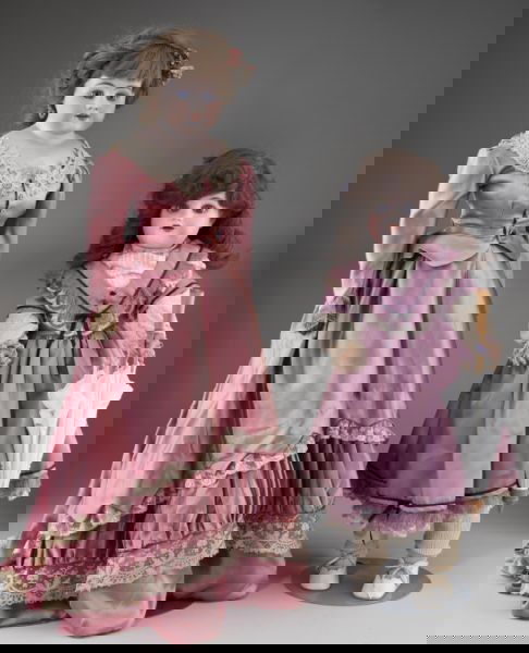 Two Simon & Halbig Dolls: Two Simon & Halbig Dolls the first, marked "S 10 H 1010" is a 28 inch tall bisque shoulder head circa 1900 with stationery paperweight eyes, open mouth with teeth, pierced ears, cloth body and upper l