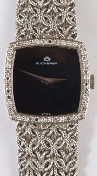 Lady's Gold and Diamond Wristwatch, Bucherer: Lady's Gold and Diamond Wristwatch, Bucherer circa 1970s, centering on a cushion shaped black dial surrounded with 44 round single cut diamonds, completed by an intricately woven gold band and fold ov