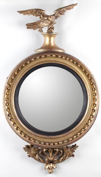 Bulls Eye Mirror with Eagle Surmount: Bulls Eye Mirror with Eagle Surmount early 19th century, featuring a full bodied spread wing eagle atop a convex glass with gilt wood frame, carved and pierced drop. 44 x 25 in. Estate Collection of t