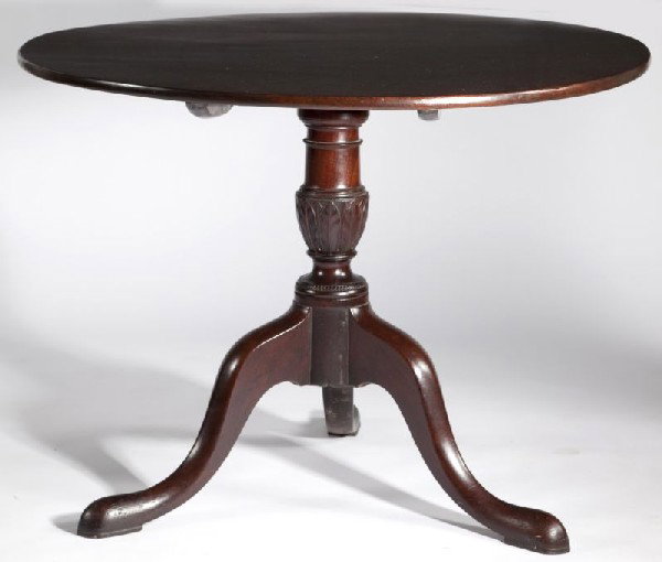 George II Tilt Top Tea Table: George II Tilt Top Tea Table 18th century, mahogany, single board highly figured top raised on an urn form standard carved with tobacco leaves, notched underside with later metal brace, cabriole leg b