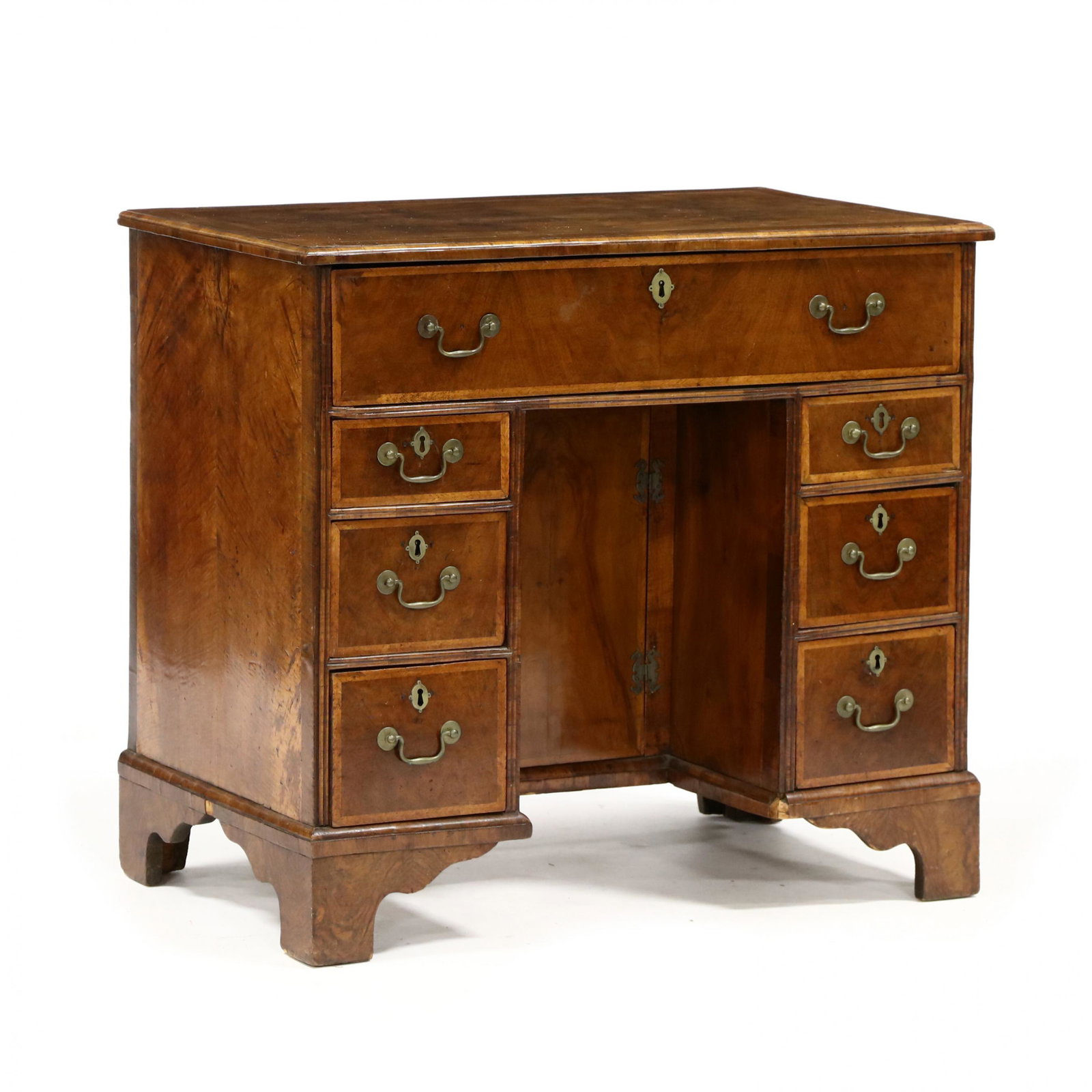 William and Mary Inlaid Kneehole Desk: William and Mary Inlaid Kneehole Desk 18th century, walnut and mixed wood veneers, oak secondary, top with book-matched figure wood panels and herringbone surround, applied molded edge, one over six g