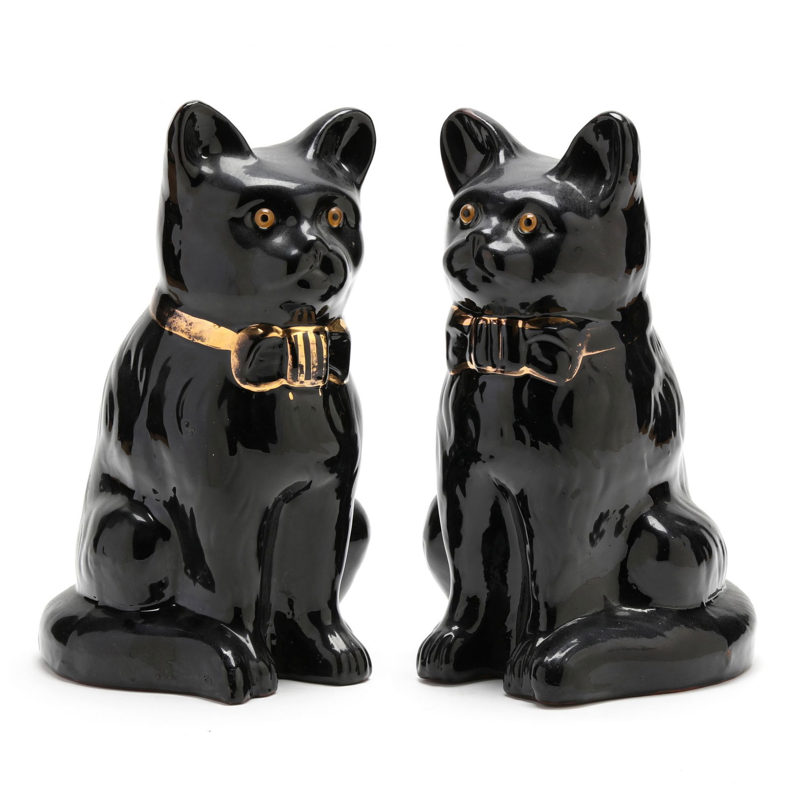 Pair of Large Sadler Burslem Cats: Pair of Large Sadler Burslem Catsearly 20th century, enameled black pottery with gold edged neck-bows and inset glass eyes, each stamped to unglazed redware foot rims, "Sadler / Burslem / England". 12