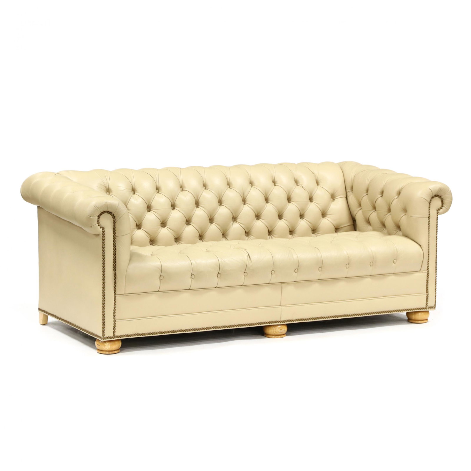 Leather Chesterfield Sofa: Leather Chesterfield Sofa late 20th century, cream colored leather with rolled and tufted arms, back and seat, brass nail head trim, turned oak feet, unmarked. 27 x 75 x 34 in. Additional high-resolut