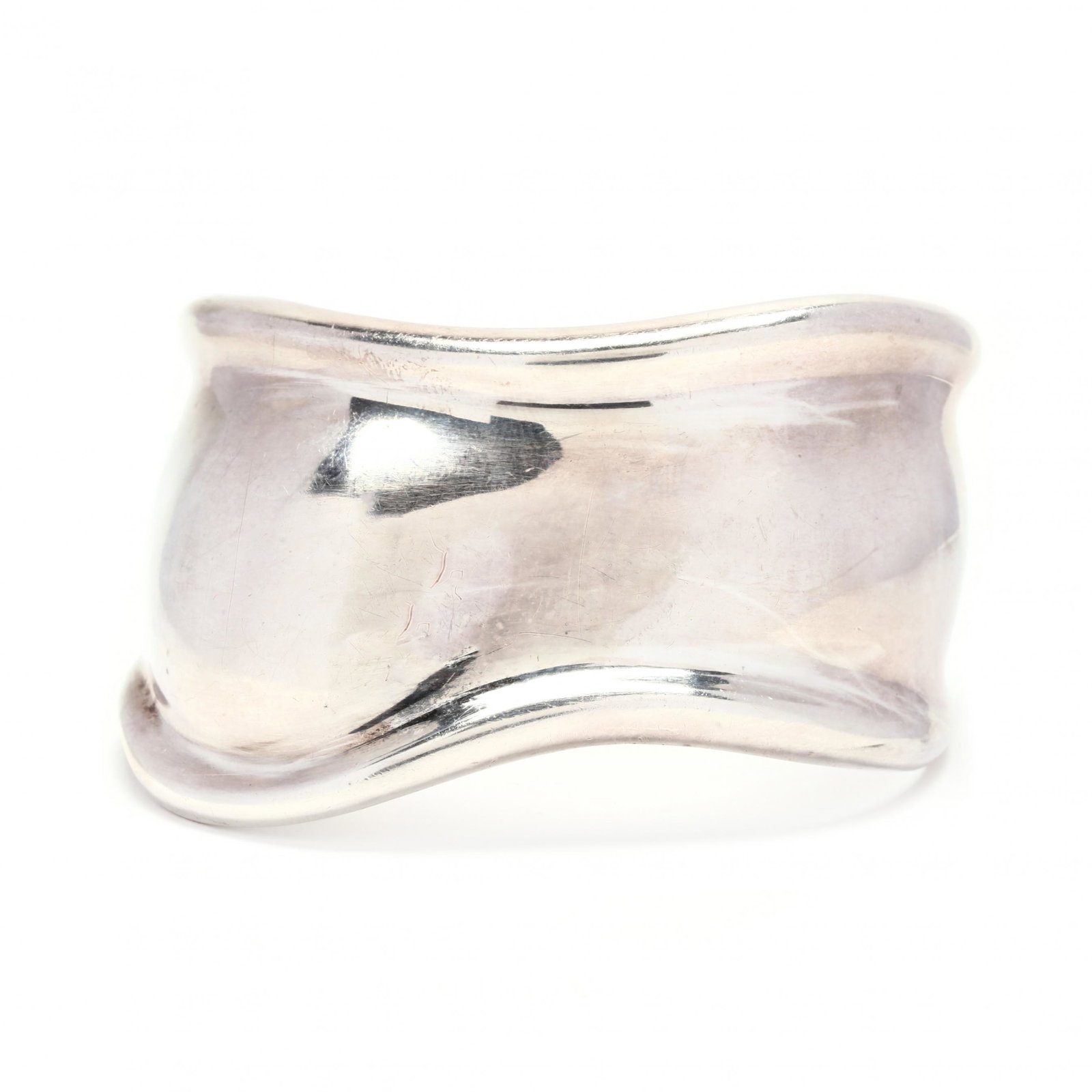 Sterling Silver Bone Cuff Bracelet, Elsa Peretti for: Sterling Silver Bone Cuff Bracelet, Elsa Peretti for Tiffany & Co. shaped cuff with undulating design and raised border, stamped Peretti - Tiffany & Co. / Spain / Sterling / 1978. 43mm; 5 in. interior