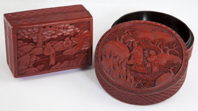 Two Chinese Carved Cinnabar Boxes: Two Chinese Carved Cinnabar Boxes 20th century, a circular one depicting a scholar and attendant on the lid (2 x 4.25 in.) and a rectangular covered box carved with children in a landscape setting (1.